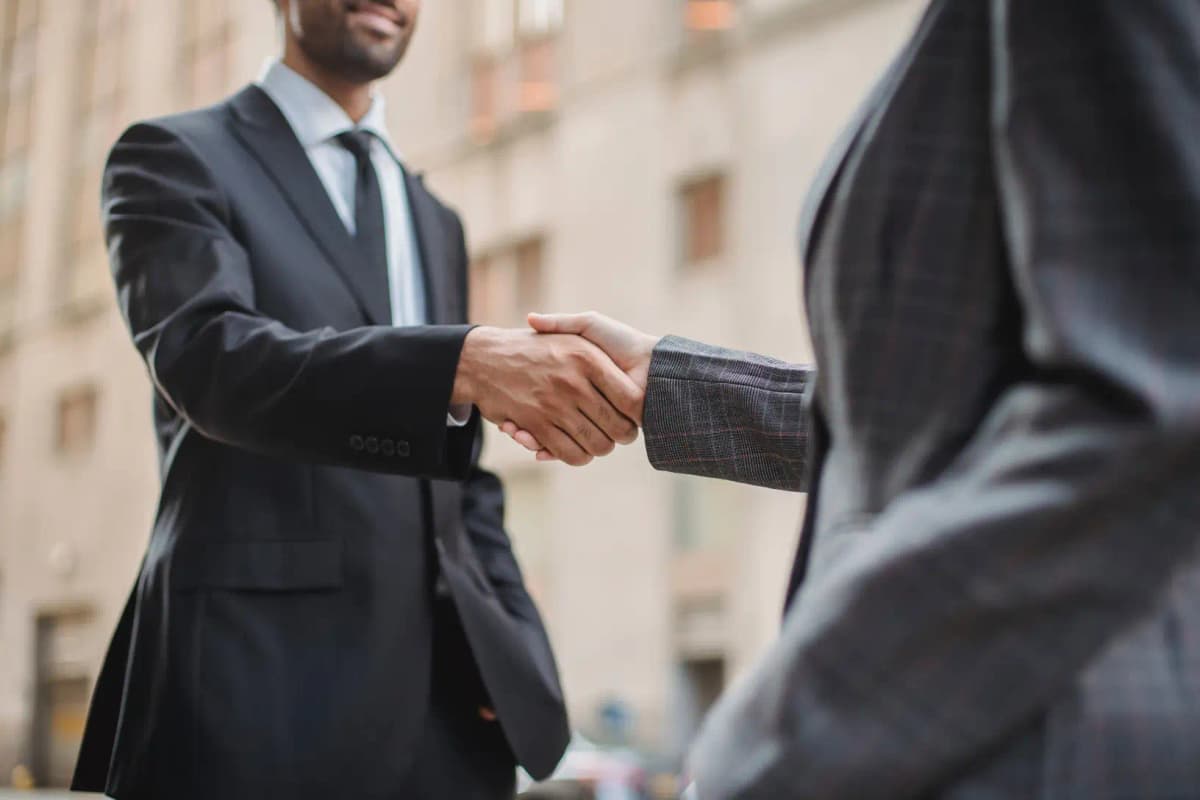 Diverse team of real estate professionals shaking hands